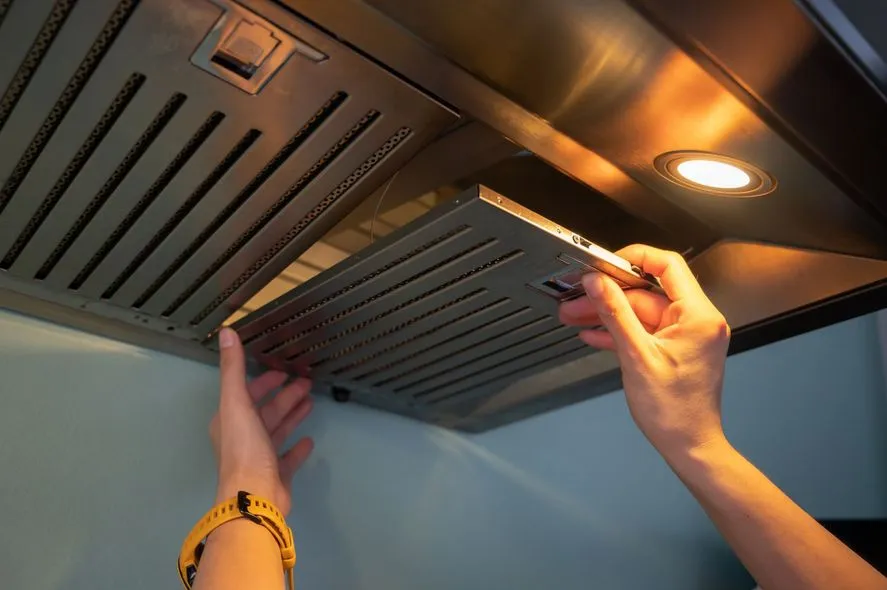 Professional cleaning a stainless steel hood